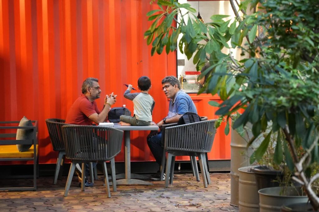Individuals engaged in conversation at a table